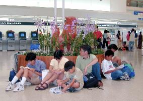 Powerful typhoon force passengers to wait at airport